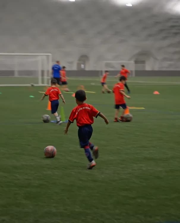 Academy kid driving forward with the ball